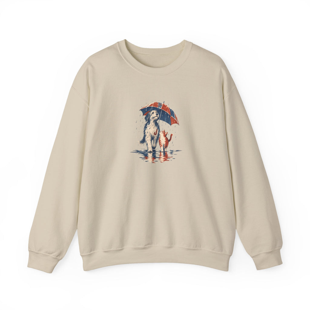 Sand Gildan 18000 crewneck sweatshirt with a dog and cat sharing one umbrella in the rain, aged screenprint-style graphic