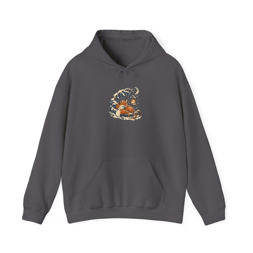Charcoal Gildan 18500 pullover hoodie with a fox curled beside a lantern on a snowy pine branch, folk screenprint-style graphic
