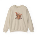 Sand Gildan 18000 crewneck sweatshirt with cupped hands shaping clay on a pottery wheel, worn screenprint-style graphic